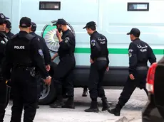 epa08039141 Algerian policemen stand next to a police vehicle carrying the two Algerian former Prime Ministers Abdelmalek Sellal and Ahmed Ouyahia at the Court of Sidi Mhamed of Algiers, Algeria, 02 December 2019. The two former prime ministers under the Bouteflika regime will appear before the judge on charges of money laundering and corruption. EPA/MOHAMED MESSARA