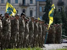 epa11503767 Servicemen of the Azov battalion attend a ceremony to remember the victims of the Olenivka camp explosion, on the Independence Square in Kyiv, 28 July 2024, amid the Russian invasion. On 29 July 2022 a building housing Ukrainian prisoners of war in Olenivka, eastern Ukraine, was destroyed, killing more than 50 people. According to Ukraine, the majority of the prisoners were soldiers from the Azovstal complex of Mariupol. Ukraine and Russia accused each other of being behind the attack. EPA/SERGEY DOLZHENKO