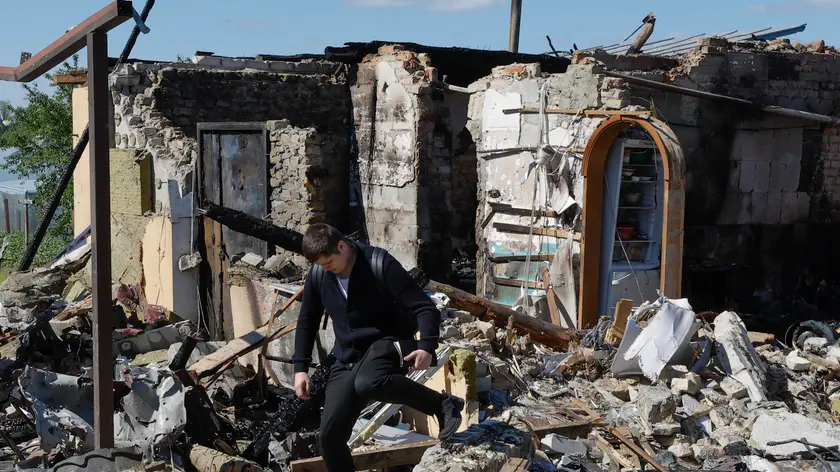epa11326502 A man walks at the site of a damaged private building after an overnight rocket attack in Krasylivka village, near Kyiv, Ukraine, 08 May 2024 amid the Russian invasion. 39 missiles and 20 shock drones were shot down, the Air Force Command of UA Armed Forces reported on 08 May. Two people were injured and 13 private buildings were damaged as a result of rocket debris falling in the Kyiv region during the Russian shelling. Russian troops launched a combined strike overnight with missiles of various types and shock drones around all of Ukraine, the Ukrainian armed forces said. EPA/SERGEY DOLZHENKO