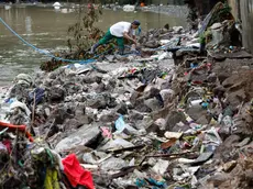 epa11581218 A resident walks along a damaged creek side area in a flood-affected village in Antipolo, Rizal province, about 40 kilometers east of Manila, Philippines, 03 September 2024. According to a 03 September report by the National Disaster Risk Reduction and Management Council (NDRRMC), ten people have died, ten have been injured, and thousands of residents left their homes due to flooding in the wake of Typhoon Yagi. EPA/ROLEX DELA PENA