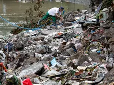 epa11581218 A resident walks along a damaged creek side area in a flood-affected village in Antipolo, Rizal province, about 40 kilometers east of Manila, Philippines, 03 September 2024. According to a 03 September report by the National Disaster Risk Reduction and Management Council (NDRRMC), ten people have died, ten have been injured, and thousands of residents left their homes due to flooding in the wake of Typhoon Yagi. EPA/ROLEX DELA PENA