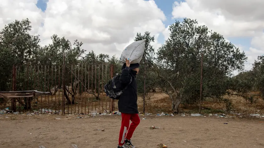 epa11321295 An internally displaced Palestinian carries belongings after an evacuation order issued by the Israeli army, in Rafah, southern Gaza Strip, 06 May 2024. The Israeli military stated on 06 May that the IDF has called on the residents of eastern Rafah to 'temporarily' evacuate to an expanded humanitarian area. The statement came ahead of an expected Israeli offensive on the city. More than 34,600 Palestinians and over 1,455 Israelis have been killed, according to the Palestinian Health Ministry and the Israel Defense Forces (IDF), since Hamas militants launched an attack against Israel from the Gaza Strip on 07 October 2023, and the Israeli operations in Gaza and the West Bank which followed it. EPA/HAITHAM IMAD