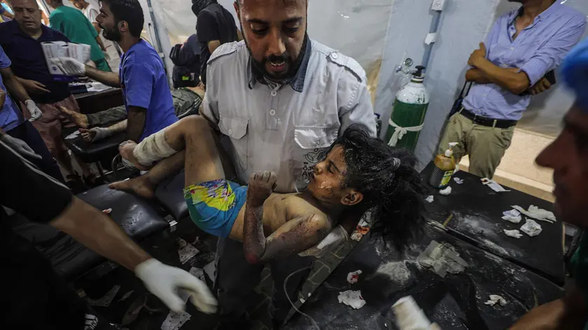 epa11397515 A Palestinian medic carries a wounded girl at Al Awda mosque during an Israeli military operation in Al Nusairat refugee camp in the central Gaza Strip on, 08 June 2024. More than 36,000 Palestinians and over 1,400 Israelis have been killed, according to the Palestinian Health Ministry and the Israel Defense Forces (IDF), since Hamas militants launched an attack against Israel from the Gaza Strip on 07 October 2023, and the Israeli operations in Gaza and the West Bank which followed it. EPA/MOHAMMED SABER