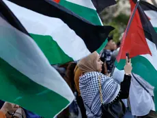 epa11277104 Protesters hold Palestinian flags during a pro-Palestinian rally called by the Palestinian Community and the 'Plataforma Valencia Amb Palestina' platform held at Valencia's City Hall square in Valencia, eastern Spain, 13 April 2024. More than 33,600 Palestinians and over 1,450 Israelis have been killed, according to the Palestinian Health Ministry and the Israel Defense Forces (IDF), since Hamas militants launched an attack against Israel from the Gaza Strip on 07 October 2023, and the Israeli operations in Gaza and the West Bank which followed it. EPA/Kai Foersterling