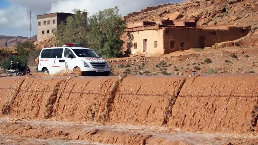 epa04502458 An ambulance crosses a bridge over the flood waters in Tnghir, south of Morocco, 24 November 2014. The Government of Morocco indicates that heavy flooding in the south has killed at least 32 people after heavy rains of the weekend. According to news reports, two dams on major rivers in the south-east are above their reservoir capacity and are being monitored by authorities. EPA/STR