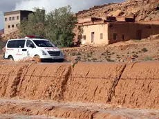 epa04502458 An ambulance crosses a bridge over the flood waters in Tnghir, south of Morocco, 24 November 2014. The Government of Morocco indicates that heavy flooding in the south has killed at least 32 people after heavy rains of the weekend. According to news reports, two dams on major rivers in the south-east are above their reservoir capacity and are being monitored by authorities. EPA/STR