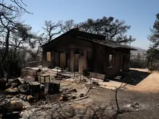 epa11547399 A burnt house after a wildfire in the area of Vrilissia close to Athens city, Greece, 13 August 2024. A wildfire that broke out on 11 August in the outskirts of Athens and spread to a large part of northeastern Attica no longer had a single front on 13 August. The fire stretched along a front more than 30 kilometres in length. According to the Fire Brigade, the firefighting forces are dealing with scattered pockets of fire from Varnavas to Nea Makri and Penteli while there are constant rekindlings. Firefighters found a charred body, of a 60-year-old woman, in a small factory that caught fire in Patima Halandriou. EPA/GEORGE VITSARAS