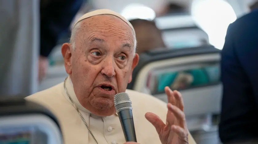 Pope Francis talks to journalists on the flight back to Rome at the end of his four-day visit to Belgium and Luxembourg, Sunday, Sept. 29, 2024. (AP Photo/Andrew Medichini, Pool)