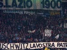 FILE - In this Nov. 29, 1998 file photo, Lazio fans display banners from the stands reading "Auschwitz is Your Homeland. The Ovens are Your Homes" during a Serie A match between Lazio and AS Roma, at Rome's Olympic stadium. Lazio fans have a long history of racism and anti-Semitism but the Roman club's supporters established a new low on Sunday, Oct. 22, 2017 when they littered the Stadio Olimpico with superimposed images of Anne Frank _ the young diarist who died in the Holocaust _ wearing a Roma jersey. (ANSA/AP Photo/Plinio Lepri, files) [CopyrightNotice: AP1998]
