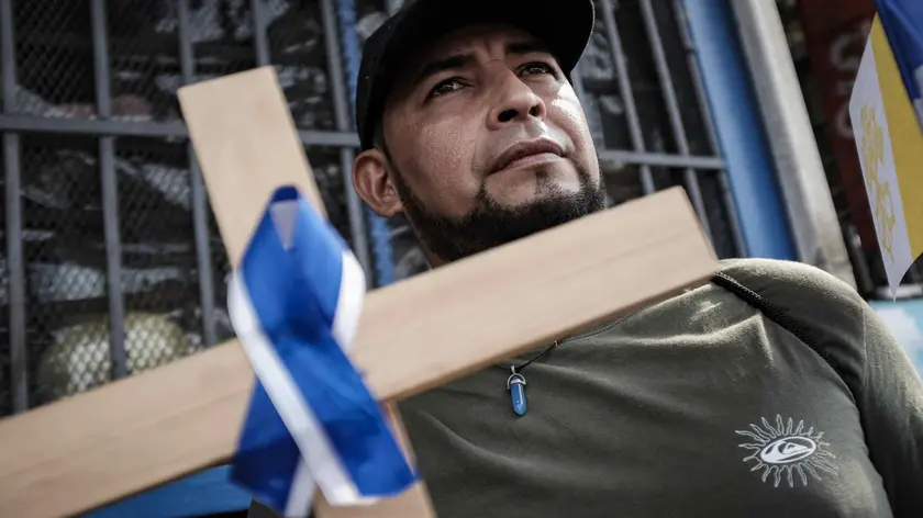 epa11240260 Nicaraguan citizens participate in a procession in San Jose, Costa Rica, 23 March 2024. The Catholic Church of Costa Rica celebrated this 23 March a Stations of the Cross for migrants, mainly Nicaraguans, for the release of the 'political prisoners' of Nicaragua' while praying for peace and for the persecuted priests in that Central American country. The viacrucis, attended by dozens of Nicaraguan migrants carrying, in some cases, the Nicaraguan flag and photographs of the 'political prisoners', left the San Isidro Labrador parish, in the Vazquez de Coronado canton, province of San Jose, Costa Rica, as confirmed by EFE. EPA/Jeffrey Arguedas