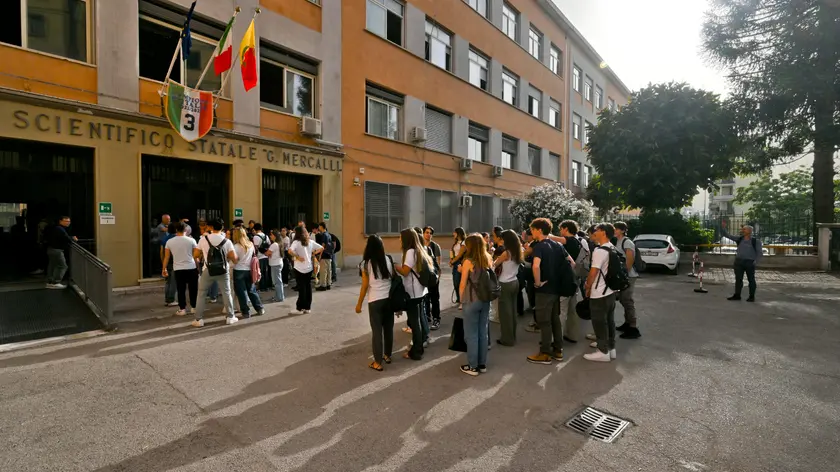 Studentesse e studenti con il vocabolario di italiano sotto braccio aspettano l'apertura della scuola al liceo Mercalli di Napoli, 21 giugno 2023. Da stamattina oltre 536.000 studenti saranno alle prese in Italia con gli esami di Maturità. E quest'anno si torna alla formula pre-Covid, con due scritti e un colloquio. Oggi si parte con la prima prova, quella di Italiano. ANSA/CIRO FUSCO Final exam at the Mercalli high school in Naples, 21 June 2023. From this morning over 536,000 students in Italy will be grappling with the final exams. And this year we return to the pre-Covid formula, with two writings and an interview. Today we start with the first test, that of Italian. ANSA/CIRO FUSCO