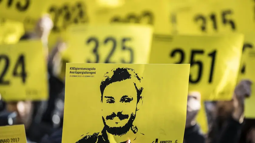 People hold signs depicting Giulio Regeni and reading ''365 days without Giulio'' as they attend a march in memory of the Italian researcher at Sapienza University on the first anniversary of his disappearance in Egypt, Rome, Italy, 25 January 2017. ANSA/MASSIMO PERCOSSI