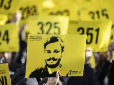 People hold signs depicting Giulio Regeni and reading ''365 days without Giulio'' as they attend a march in memory of the Italian researcher at Sapienza University on the first anniversary of his disappearance in Egypt, Rome, Italy, 25 January 2017. ANSA/MASSIMO PERCOSSI
