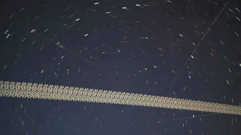 epa09194540 A digital stacked combination of multiple exposures shows a train of brightly-lit SpaceX Starlink 24 mission satellites pass the night sky in train formation near Herrnleis, Austria, 09 May 2021 (issued 12 May 2021). A SpaceX Falcon 9 rocket launched the Starlink 24 mission by US space company SpaceX from Kennedy Space Center in Florida on 07 April 2021. The Starlink mass-produced satellites in low Earth orbit (LEO) work in satellite internet constellations to provide future customers with access to high-speed Internet. EPA/CHRISTIAN BRUNA