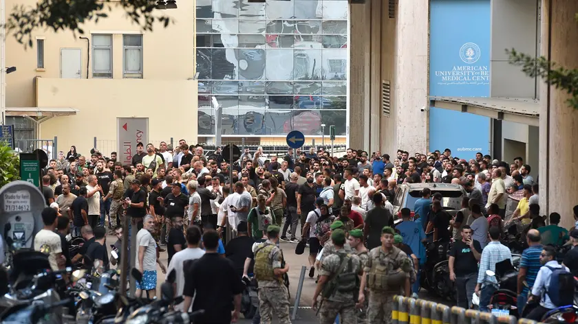 epa11610085 Lebanese soldiers and Hezbollah members gather outside the American University of Beirut Medical Center (AUBMC) after an incident involving Hezbollah members' wireless devices in Beirut, Lebanon, 17 September 2024. According to the Lebanese Health minister, at least eight people died and more than 2.500 were injured. 'Several wireless communication devices (pagers) were detonated using advanced technology’, the state news agency said. EPA/WAEL HAMZEH
