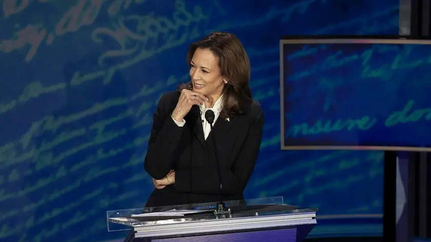 epa11597550 Democratic presidential candidate US Vice President Kamala Harris listens to Republican presidential candidate Donald J. Trump during a presidential debate hosted by ABC News at the National Constitution Center in Philadelphia, Pennsylvania, USA 10 September 2024. The 90 minute event is the only planned debate between the two candidates in the 2024 presidential election. EPA/DEMETRIUS FREEMAN / POOL