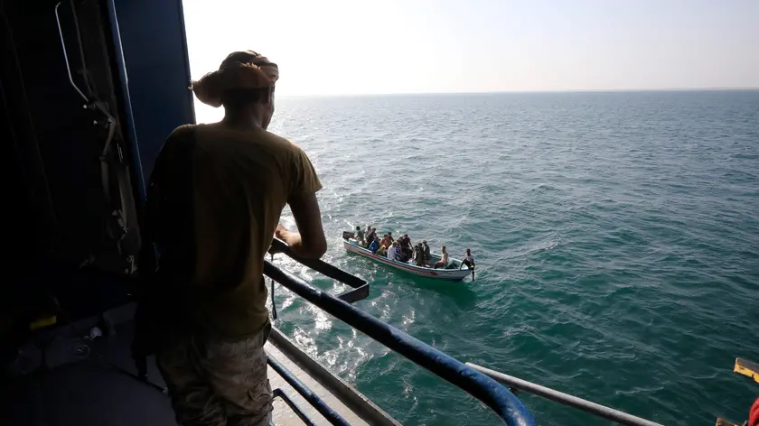 epa11014311 A boat carries people as a Houthi fighter keeps watch on the deck of the Galaxy Leader cargo ship, seized by the Houthis offshore of the Al-Salif port on the Red Sea in the province of Hodeidah, Yemen, 05 December 2023 (issued 06 December 2023). Yemen's Houthis on 06 December 2023 claimed responsibility for the launch of the barrage of ballistic missiles toward Israel in support of the Palestinian people in the Gaza Strip, according to a statement by Houthis spokesman Yahya Saree. The Houthis vowed to continue their efforts to prevent Israeli ships from navigating in the Arabian and Red Seas, in retaliation for Israel's airstrikes on the Gaza Strip. Thousands of Israelis and Palestinians have died since the militant group Hamas launched an unprecedented attack on Israel from the Gaza Strip on 07 October, and the Israeli strikes on the Palestinian enclave which followed it. EPA/YAHYA ARHAB