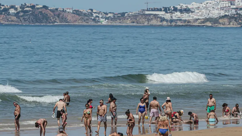 epa08441193 People enjoy the beach in Loule, Algarve, 24 May 2020. With the increase in temperature, the beach was the destination sought by some Portuguese after emergency measures were relieved due to the epidemiological situation of covid-19. Portugal and the United Kingdom are negotiating the creation of a bilateral tourism corridor to ensure such travel because English are the main market for tourists in the Algarve. EPA/LUIS FORRA
