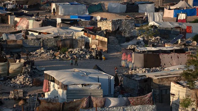 epa11523277 Internally displaced Palestinians at a makeshift camp built among the rubble in Khan Younis, southern Gaza Strip, 03 August 2024. Since 07 October 2023, up to 1.7 million people, or more than 75 percent of the population, have been displaced throughout the Gaza Strip, some more than once, in search of safety, according to the United Nations Relief and Works Agency for Palestine Refugees in the Near East (UNRWA), which added that the Palestinian enclave is 'on the brink of famine', with 1.1 million people (half of its population) 'experiencing catastrophic food insecurity' due to the conflict and restrictions on humanitarian access. EPA/HAITHAM IMAD