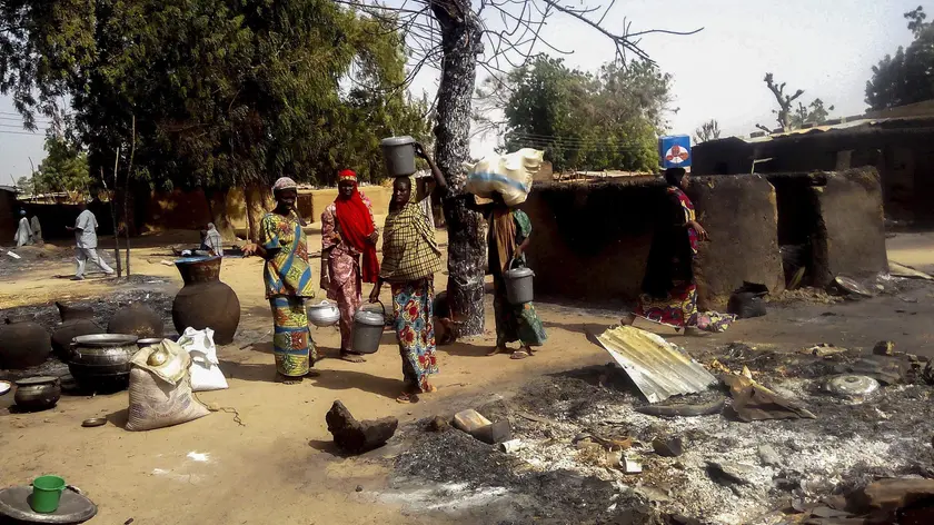epa05149785 Nigerian women gather their belongings to depart the village of Mairi in the Konduga local government area of Borno State, North-East Nigeria following Boko Haram attacks over the weekend, Nigeria 08 February 2016. Three women and one man were killed during the attack which led to the destruction of the village. Nigerian military have been carrying out operations against Boko Haram following the recent Boko Haram attacks. Boko Haram insurgents have been waging a terror campaign in Northeast Nigeria for over 5 years. EPA/STRINGER