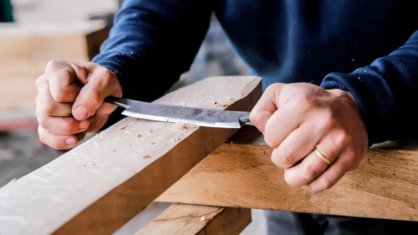 epa10653047 Edouard Cortes makes keys to solidify the sets for the strcucture of the medieval choir frame for Notre Dame de Paris during a press visit at the installations of Ateliers Perrault in Saint Laurent de la Plaine, France, 25 May 2023. Ateliers Perrault and Remy Desmonts Carpentry are responsible for the reconstruction of the medieval choir frame of Notre-Dame Cathedral in Paris following its destruction by fire on 15 April 2019. Twenty-two carpenters from all over France have been working together for the past four years to rebuild the carpentry in the traditional way to reopen the cathedral before the end of 2024. EPA/TERESA SUAREZ