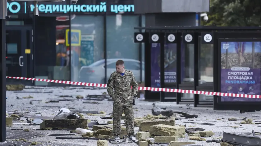epaselect epa10776525 An official inspects debris at the site of a damaged building following a reported drone attack in Moscow, Russia, 30 July 2023. The Russian Ministry of Defense on 30 July accused Ukraine of carrying out an attack with three unmanned aerial vehicles (UAV) against facilities in Moscow, adding that the attack was foiled and the three UAVs 'were suppressed by means of electronic warfare and crashed' leaving no casualties. EPA/YURI KOCHETKOV