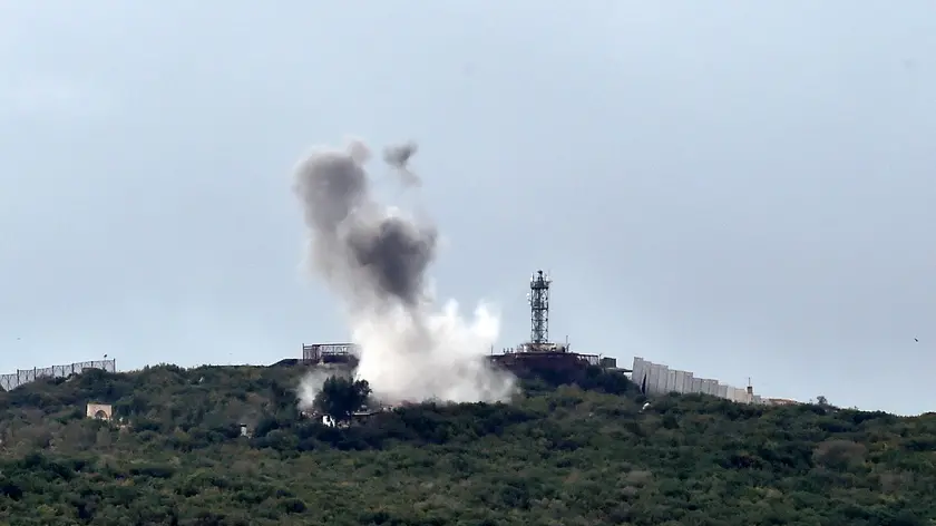 epa10920596 Smoke rises after Hezbollah targeted an Israeli army post in the vicinity of Ayta ash-Shab village, near the Lebanese-Israeli border, Lebanon, 15 October 2023. According to the Israeli Defense Forces (IDF), anti-tank missiles were fired at soldiers operating along the Lebanese border, and Israeli forces responded by striking Hezbollah military targets. EPA/WAEL HAMZEH