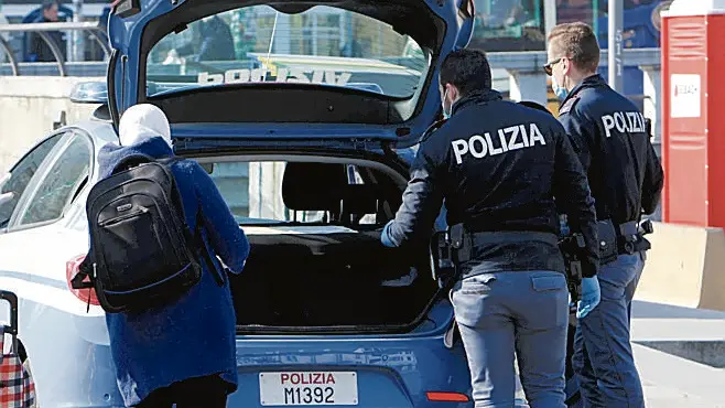 Agenti della Polizia di Stato verificano la conformità dell'autocertificazione di due donne uscite di casa per fare la spesa, Milano, 2 aprile 2020. Nella giornata del 1° aprile, a Milano, le forze dell'ordine hanno eseguito 12.821 controlli a persone, sanzionandone 357. Inoltre sonoo stati controllati 4.787 esercizi commerciali e 10 titolari sono stato denunciati. ANSA / PAOLO SALMOIRAGO