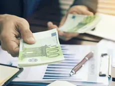 The hands of business people who are spending euros
