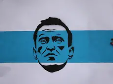 epaselect epa11163499 A participant holds a Russian white-blue-white flag showing a portrait of deceased Alexei Navalny during a rally in reaction to the death of Russian opposition leader Alexei Navalny in front of the Russian embassy, in Berlin, Germany, 18 February 2024. Russian opposition leader and outspoken Kremlin critic Alexei Navalny has died aged 47 in a penal colony, the Federal Penitentiary Service of the Yamalo-Nenets Autonomous District announced on 16 February 2024. A prison service statement said that Navalny 'felt unwell' after a walk on 16 February, and it was investigating the causes of his death. In late 2023 Navalny was transferred to an Arctic penal colony considered one of the harshest prisons. EPA/CLEMENS BILAN