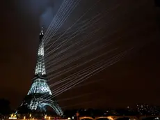 epa11498168 The Eiffel Tower is illuminated by a light show during the Opening Ceremony of the Paris 2024 Olympic Games, in Paris, France, 26 July 2024. EPA/DAVID DAVIES / POOL