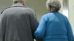 An elderly couple walk down a corridor in the pro vita Haus Rheingold nursing home for the elderly in Berlin, Germany, 5 December 2012. Photo: Jens Kalaene - Infophoto