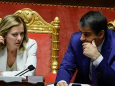 epa11439114 Italian Prime Minister Giorgia Meloni and Italian Minister for European Affairs, Territorial Cohesion and PNRR Raffaele Fitto talk during a report to the Senate ahead of the EU summit, in Rome, Italy, 26 June 2024. The next European Council takes place in Brussels on 27 and 28 June, with EU leaders deciding the key appointments for the next institutional cycle. EPA/FABIO FRUSTACI