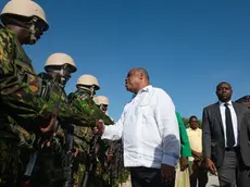 epa11439678 Haiti's Prime Minister Garry Conille (C) greets Kenyan police officers during a visit to the Multinational Mission base in Port-au-Prince, Haiti, 26 June 2024. The first Kenyan police deployed in Haiti, in response to an international request for assistance, begin to engage with a country they will help in addressing violence and restoring normalcy after years of crisis. EPA/Johnson Sabin