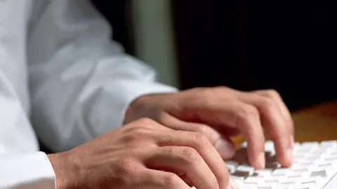 using desktop computer keyboard --- Image by © Ocean/Corbis