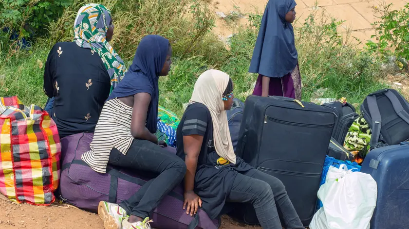 epa10860772 A group of women wait to board dugouts on the Sota river, an affluent of the Niger river, across to Niger near the border town of Malanville, Benin, 12 September 2023, (issued 14 September 2023). Following the coup in Niger on 26 July, Benin closed its border in accordance with one of the decisions taken by the Economic Community of West African States (ECOWAS). As legal cross-boundary road traffic for people, produce and consumer goods has come to a halt in the border town, people are turning to other means to ship their goods from both sides of the Niger River from both sides. EPA/DIDER ASSOGBA