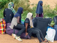 epa10860772 A group of women wait to board dugouts on the Sota river, an affluent of the Niger river, across to Niger near the border town of Malanville, Benin, 12 September 2023, (issued 14 September 2023). Following the coup in Niger on 26 July, Benin closed its border in accordance with one of the decisions taken by the Economic Community of West African States (ECOWAS). As legal cross-boundary road traffic for people, produce and consumer goods has come to a halt in the border town, people are turning to other means to ship their goods from both sides of the Niger River from both sides. EPA/DIDER ASSOGBA