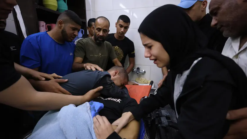 epa10948660 Relatives mourn next to the body of Palestinian Musa Jabarin at Jenin hospital after he died during clashes with Israeli forces, in the West Bank city of Jenin, 30 October 2023. According to the Palestinian Health Ministry, at least four Palestinians have been killed and five others injured during Israeli raids in Jenin. EPA/ALAA BADARNEH