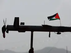 epaselect epa11573862 A Houthi supporter holds up a mock drone with a Palestinian flag during an anti-US and Israel protest, in Sana'a, Yemen, 30 August 2024. Thousands of people participated in the protest in solidarity with the Palestinian people and condemning the US support for Israel's military operation in the Gaza Strip, amid the Houthis' maritime attacks in the seas around Yemen. The Houthis have vowed a surprise response to Israeli attacks that targeted a month ago with several raids at the Hodeidah port and fuel tanks in the coastal Yemeni city of Hodeidah, according to a televised address by the Houthis' leader Abdul-Malik al-Houthi. EPA/YAHYA ARHAB