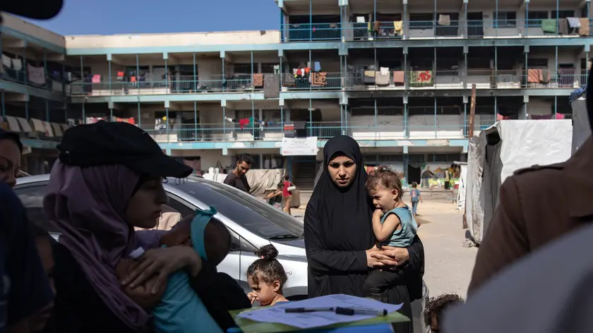 epaselect epa11586262 Palestinian children wait for polio vaccination at a UN school in Khan Yunis camp, southern Gaza Strip, 05 September 2024. According to UNICEF Regional Director for the Middle East and North Africa, Adele Khodr, the first phase of a two-round polio vaccination campaign, running from 01 to 03 September, surpassed its initial target (estimated at 157,000 children due to population movement) and reached more than 189,000 children under 10 years old in the central Gaza Strip. The rollout of the next phase of the campaign will take place in southern Gaza from 05 to 08 September 2024, targeting an estimated 340,000 children under the age of 10, the World Health Organization (WHO) said. To prevent the spread of circulating variant type 2 poliovirus (cVDPV2), a polio vaccination campaign with novel oral poliovirus vaccine type 2 (nOPV2) has been launched in the Palestinian enclave after WHO and UNICEF called for humanitarian pauses in the conflict to allow for vaccination following the discovery of the poliovirus in environmental samples from Khan Yunis and Deir Al Balah in July 2024. EPA/HAITHAM IMAD