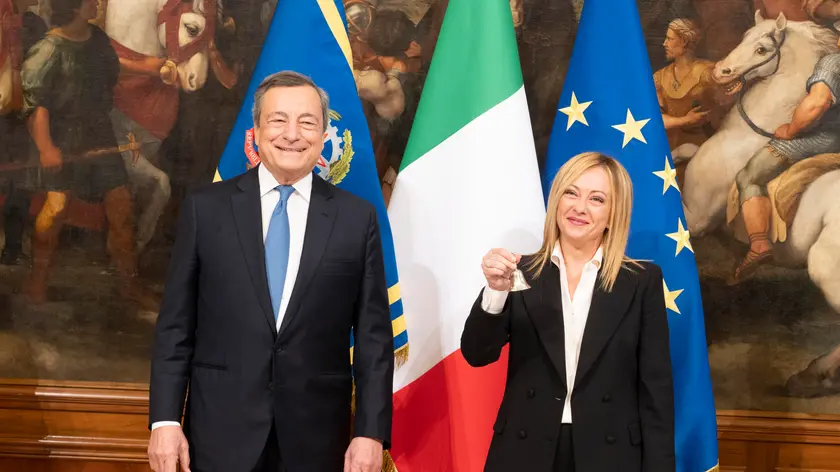 This handout picture, provided by Chigi Palace Press Office, shows Italy's outgoing Prime Minister Mario Draghi (L) hands over the bell used by the cabinet President to manage cabinet debates to Prime Minister, Giorgia Meloni (R), during the handover ceremony at Chigi Palace in Rome, Italy, 23 October 2022. Newly elected Prime Minister, Giorgia Meloni, and her cabinet were sworn in on 22 October. NPK ANSA / Filippo Attili - Chigi Palace Press Office handout +++ ANSA PROVIDES ACCESS TO THIS HANDOUT PHOTO TO BE USED SOLELY TO ILLUSTRATE NEWS REPORTING OR COMMENTARY ON THE FACTS OR EVENTS DEPICTED IN THIS IMAGE; NO ARCHIVING; NO LICENSING +++