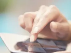 22 Feb 2015 --- Woman using tablet PC and browsing digital photography --- Image by © Arman Zhenikeyev/Corbis