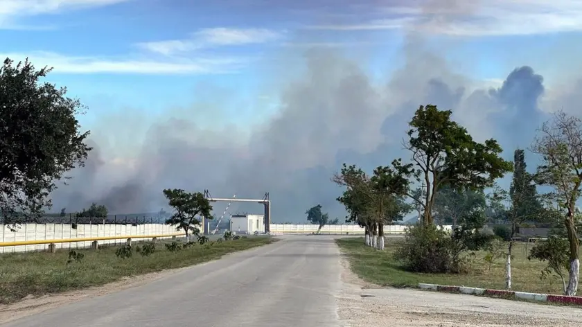 epa10112854 A handout picture made available by the Department of Information and Press Service of the Head of the Republic of Crimea shows smoke rising after detonations of air munisions at the Saki airfield near the Novofedorovka settlement, Crimea, 09 August 2022. Violation of the fire safety rules is being probed as the main cause of the explosion of ammunition at the Saki airfield in Crimea; there is no sign that they were blown up intentionally, a source at the Russian Defense Ministry said. EPA/Press Office of Head of Crimea HANDOUT MANDATORY CREDIT HANDOUT EDITORIAL USE ONLY/NO SALES