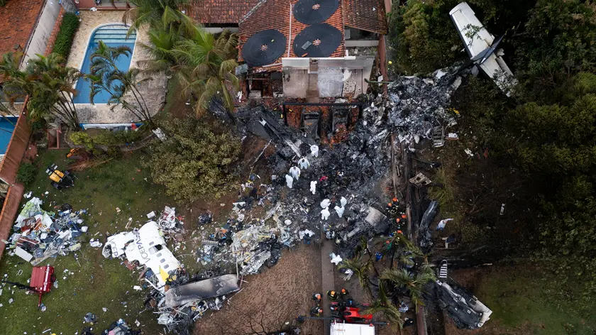 epa11542434 An aerial view shows Brazilian forensics working in the site where a Voepass airline plane crashed, in Vinhedo, Brazil, 10 August 2024. A plane with 61 people on board crashed on 09 August in a residential area of the Brazilian municipality of Vinhedo, in the state of Sao Paulo, leaving no survivors. EPA/ISAAC FONTANA