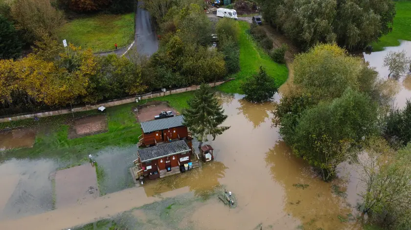 epa10949143 An aerial photograph taken with a drone shows floodwater from the River Derwent surrounding a building in Stamford Bridge, Britain, 30 October 2023. Severe flood warnings are in place in parts of North Yorkshire following weeks of heavy rain brought by storms Agnes and Babet. The Meteorological Office is forecasting strong winds and heavy rain across southern England as Storm Ciaran is expected to arrive on 01 November. EPA/ADAM VAUGHAN