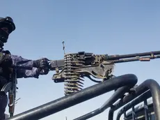 epa11071394 A Houthi soldier stands guard as people protest against a multinational operation to safeguard Red Sea shipping following Houthi attacks and the subsequent US and UK airstrikes on Houthis military sites, in Sanaa, Yemen, 12 January 2024. EPA/YAHYA ARHAB