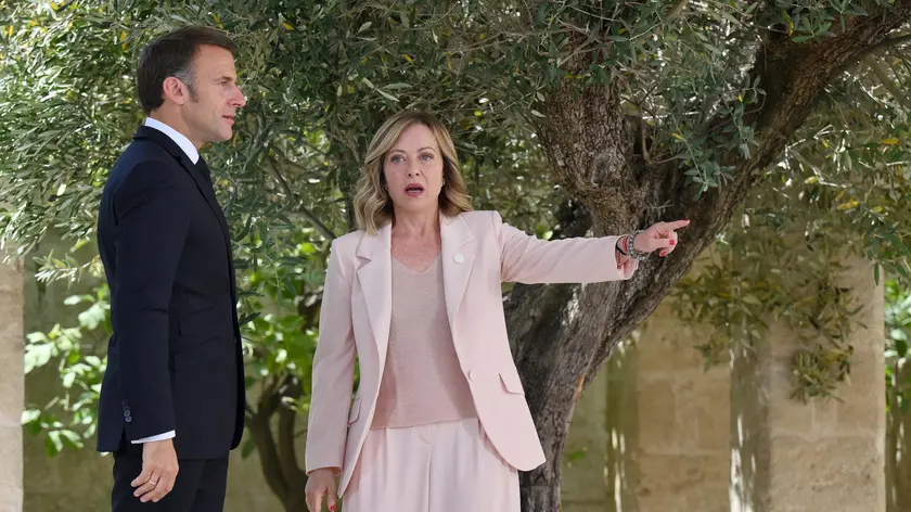 epa11407581 Italy's Prime Minister Giorgia Meloni (R) greets French President Emmanuel Macron (L) during a welcome ceremony for the G7 summit in Borgo Egnazia, southern Italy, 13 June 2024. The 50th G7 summit will bring together the Group of Seven member states leaders in Borgo Egnazia resort in southern Italy from 13 to 15 June 2024. EPA/ETTORE FERRARI