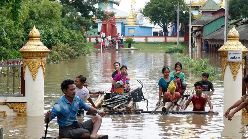epa11603217 Flood victims wade through the flood with makeshift rafts in Taungoo, Bago division, Myanmar, 14 September 2024. Heavy rains triggered by Typhoon Yagi have caused severe flooding in parts of Myanmar, leaving thousands stranded in their homes, with further heavy rainfall and thunderstorms expected, according to the state weather office. A statement from the Military announced 59,413 households were affected in 34 townships and set up 187 relief camps for the 236,649 people. There were 33 casualties due to the flood in the country including the Naypyitaw. EPA/NYEIN CHAN NAING