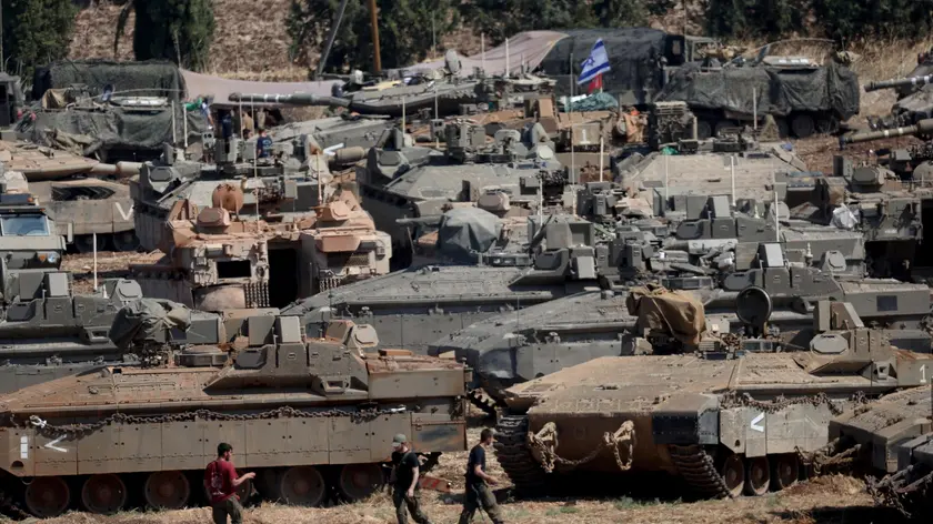 epa11633435 Israeli military vehicles at a gathering site next to the border with Lebanon as seen from an undisclosed location in northern Israel, 30 September 2024. The Israeli military announced on 30 September that it had eliminated the head of the Lebanon Branch of Hamas during an ‘overnight joining IDF and ISA intelligence-based’ operation in Lebanon.