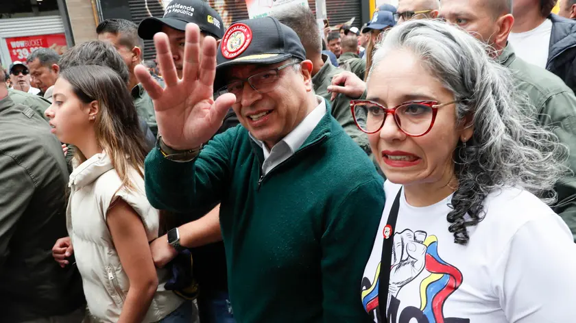 epa11312888 Colombian President Gustavo Petro (C), accompanied by Senator Maria Jose Pizarro (R), waves during a march marking International Workers' Day in Bogota, Colombia, 01 May 2024. Social and union organizations commemorate International Workers' Day with demonstrations to demand labor and salary improvements for workers. EPA/Carlos Ortega